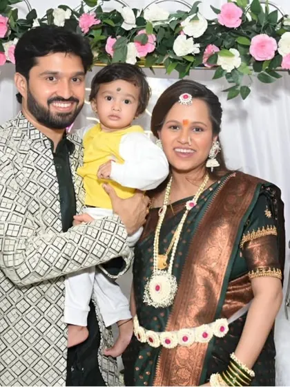 A beautiful three-generation photo, with the expecting couple and their child, capturing a special family moment during the baby shower.