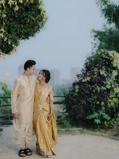 A romantic portrait of the couple against a city skyline, blending nature and urban elements in their engagement shoot.