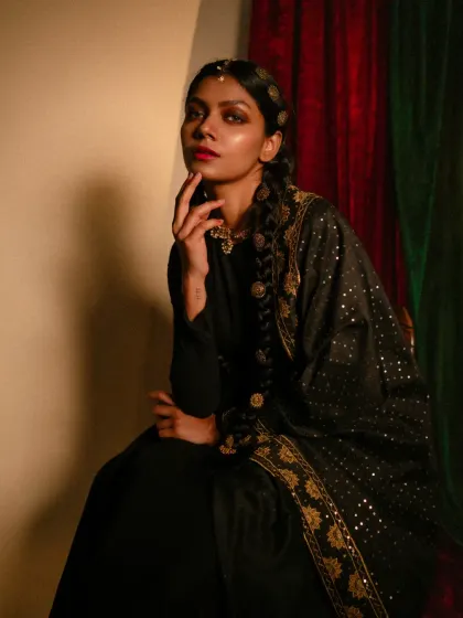 From the 'Amodini' series, this portrait blends traditional and modern aesthetics. I styled a simple black dress with an ornate dupatta and traditional hair jewelry to create a look of timeless elegance.