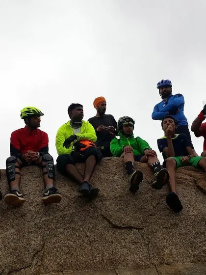Part of our crew sitting on a large boulder, chatting and relaxing during a ride.