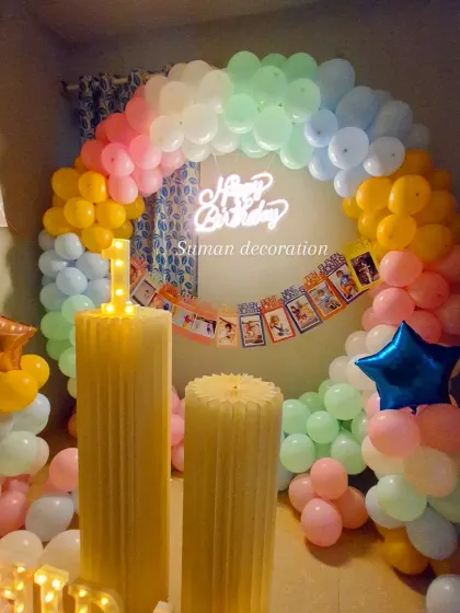 Another perspective of the pastel balloon ring, showing the 'Happy Birthday' neon sign and the light-up number '1'.