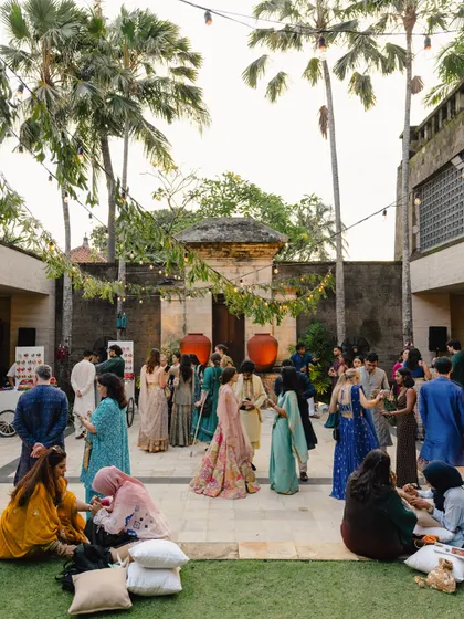 Guests enjoying the relaxed, festive atmosphere at Rishi and Krishna's wedding celebration in Bali. I focus on capturing the overall vibe and energy of the event.