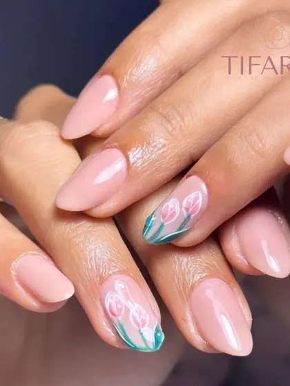Gel polish on natural nails can be a canvas for beautiful art. Here, we demonstrate delicate, hand-painted tulips, a perfect example of the fine art skills you will learn in our workshops to elevate any manicure.