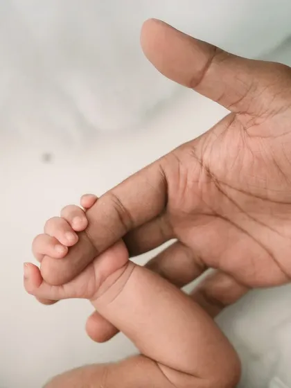 A slightly different angle, showing the baby's tiny fingers and leg. These detail shots are perfect for remembering how small they were.