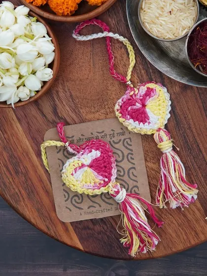 Two pink and yellow Lumbas, ready to be gifted. They make this Rakhi extra special and memorable.