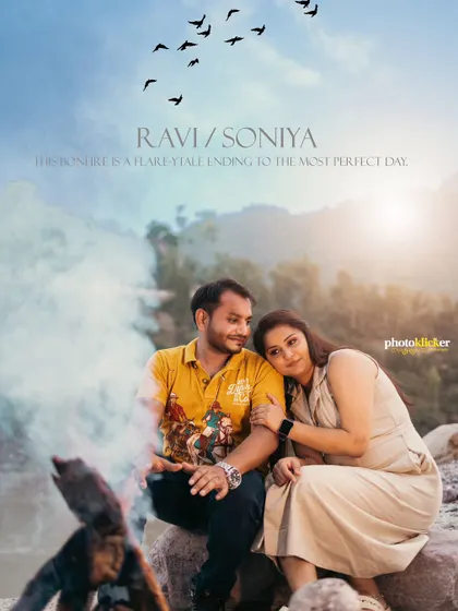 An album-style photo of a couple sitting by a bonfire on a riverbank, with smoke adding a dreamy effect to the mountain scenery.