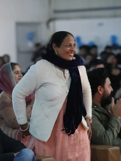 A proud parent enjoying the awards ceremony. The support of our families is the backbone of our success, and we love celebrating our achievements with them.