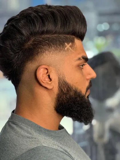 The side profile shows the perfect blend of the fade and the sharp lines of the beard.