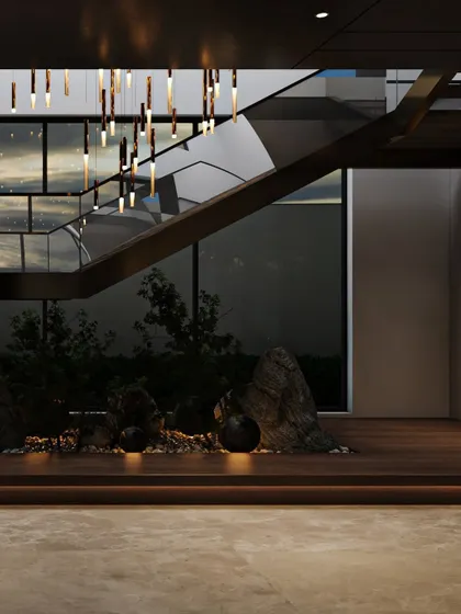 Another view of the under-staircase garden shows how it is framed by the home's architecture. The large glass wall behind it connects this indoor green space with the outdoor landscape, creating a multi-layered view of nature.