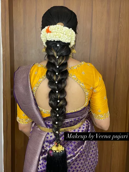 A simple and elegant braid adorned with a string of pearls. This is a classic hairstyle that is perfect for any pre-wedding function.