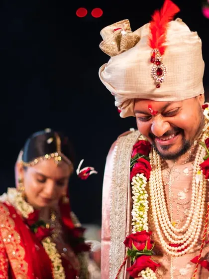 A candid shot of the groom's happy expression during the wedding rituals.