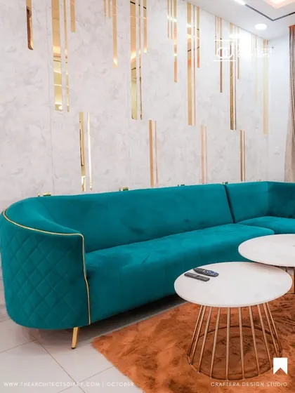 Another angle of the beautiful teal sofa, showing how it curves elegantly to define the seating area.