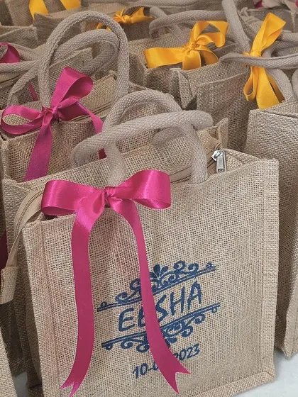 Another close-up of the jute bag with a pink ribbon, highlighting the texture of the jute material.