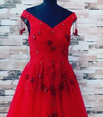 For a big celebration, I can create a custom party gown like this one in bright red. It is an off-shoulder design with detailed beadwork, perfect for making a statement at any event.
