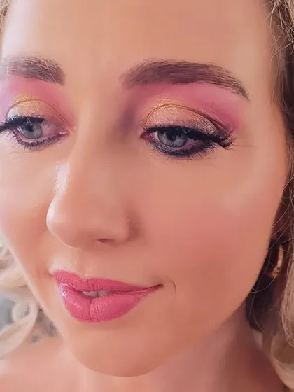 Just looking like a wow! A close-up of a vibrant and fun party look with bright pink and gold eyeshadow.