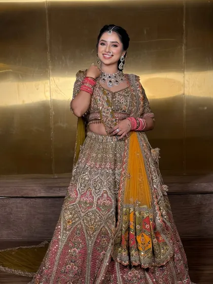 A joyful portrait of the bride in her reception lehenga. The drape is light and comfortable, perfect for an evening of celebration.