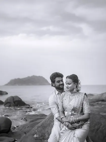 A timeless black and white portrait from a destination wedding. The rocky shore and the endless sea provide a powerful, classic backdrop for this quiet moment of togetherness.
