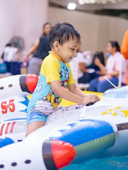 A little one enjoying a rocket ship float. We provide a variety of fun and safe pool toys to match the party's theme.