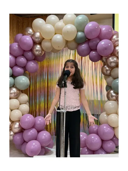 This student's expressive performance during the comedy showcase was a highlight of the evening.
