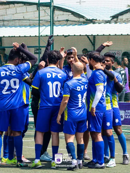 The Dell Technologies team in their blue kits, huddled together before a match. This shows the focus and unity of a team that would go on to become champions.