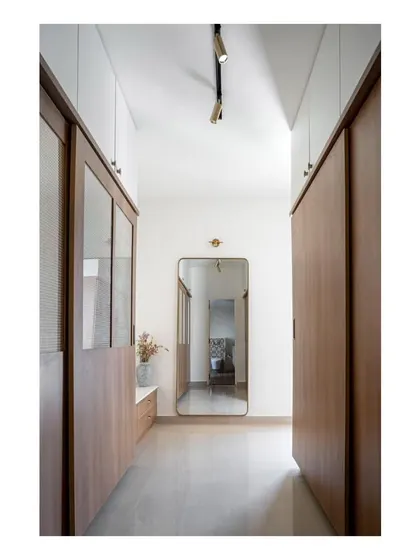 Another view of the guest room's walk-in closet, featuring sliding doors and a full-length mirror to enhance the sense of space.