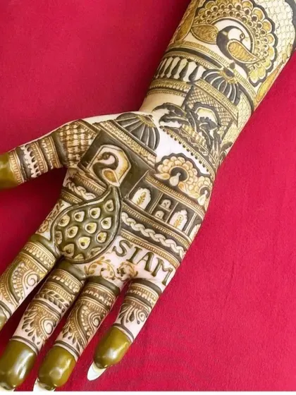 This design incorporates the client's name, 'SIAM', into a traditional Rajasthani pattern with peacocks and architecture.