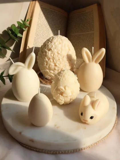 A selection of my ivory Easter candles, showing the variety of shapes and textures in the collection, from smooth eggs to floral eggs and cute bunnies.
