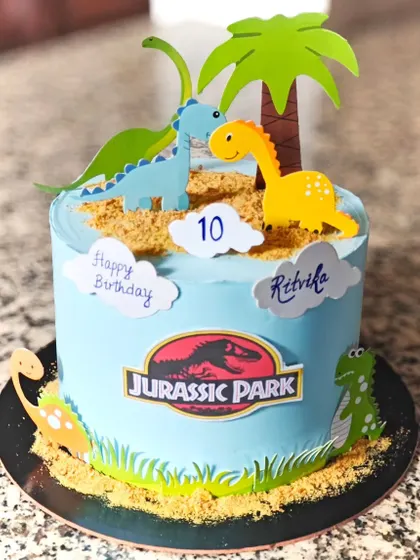 A dinosaur party on a cake. This chocolate truffle cake uses cardboard cutouts for a Jurassic Park theme, which is a great budget-friendly option if you prefer to avoid too much fondant.