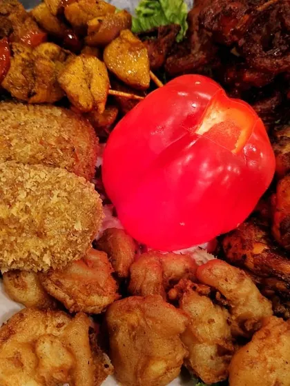 A close-up of one of our mixed non-veg platters. You can see the variety, from crispy crumb-fried cutlets and golden fried prawns to spicy chicken tikkas and sheesh kebabs.