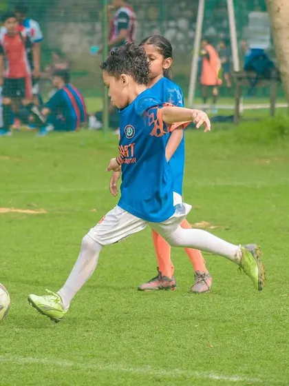 A young player strikes the ball with precision, a skill honed through dedicated practice and match experience.