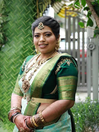 Priyanka's Bale Shastra look. For this traditional ceremony, we chose a beautiful light blue and green saree, and I created a classic makeup look with a bold lip and defined eyes.