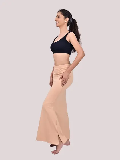A side view of my beige shapewear, showing its flattering mermaid cut and the side slit for easy movement.