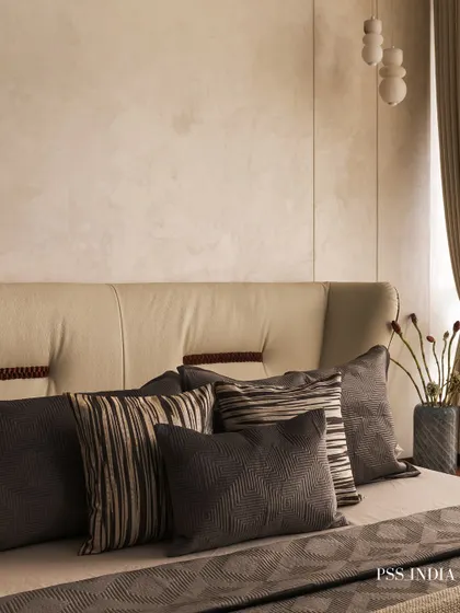 Beige is never boring when done right. In this room, I layered various shades and textures of grey and beige, from the upholstered headboard to the throw pillows and linens, to create a sophisticated, monochrome look.