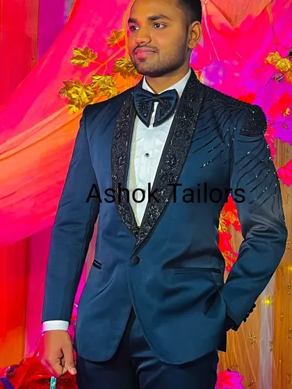 A happy client at his event, wearing our blue tuxedo with black sequin detailing on the lapels and shoulders. It’s a perfect outfit for a reception or sangeet night.