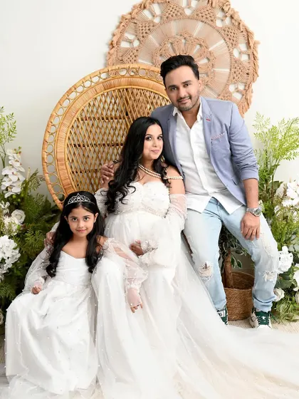 A perfect family portrait in our boho-chic setup. I love including older siblings and coordinating outfits, like this mother-daughter duo in matching white gowns, to create sweet, connected memories.