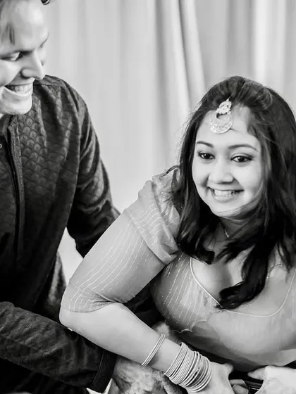 The bride's sister, happy with her successful negotiation, is surrounded by the groom's brothers. A fun, candid moment.