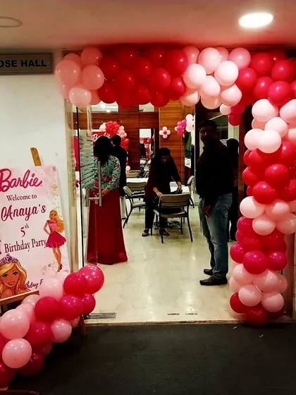 The entrance to Anaya's Barbie party featured a beautiful pink and red organic balloon arch and a custom welcome sign, setting the stage for a fabulous celebration.