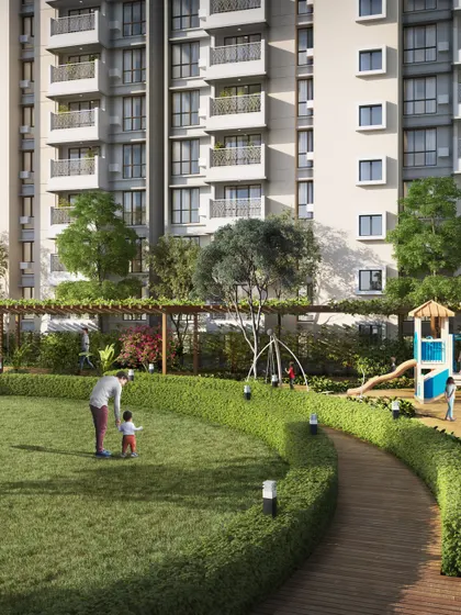 A rendering of a large lawn and play area for families. The image shows parents and children enjoying the open space, emphasizing the community-oriented design of the development.