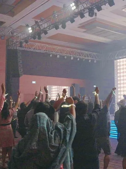 A view from the back of the room, with everyone's hands up. It's an amazing feeling to see a whole room united by the music.