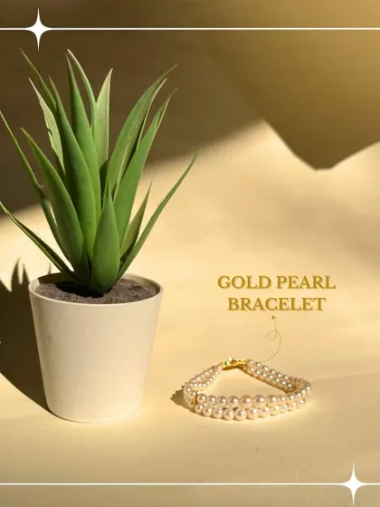 The soft lustre of this gold and pearl bracelet offers a touch of classic grace. It is a reflection of timeless beauty, perfect for any occasion.