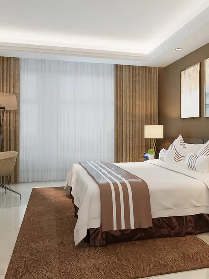 This hotel-like bedroom design uses a palette of brown and beige, with elegant curtains and abstract art to create a sophisticated and restful environment.