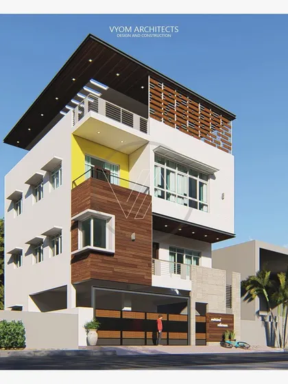 A different perspective of the Vishal residence, showing the interplay of yellow accent color, wood paneling, and cantilevered window shades.