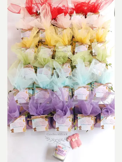 A rainbow of gift boxes for a baby shower, showing how we can coordinate the packaging with the colors of the candles and sachets inside for a complete look.