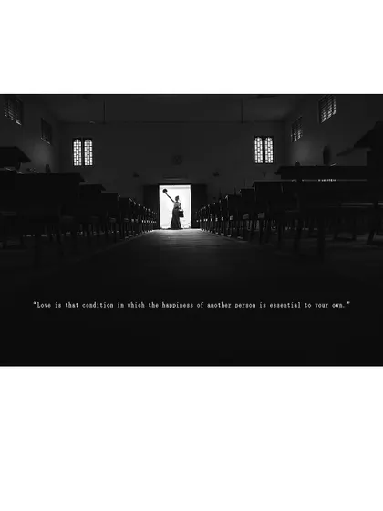 A striking silhouette of the bride standing alone in the church aisle, a moment of quiet contemplation.