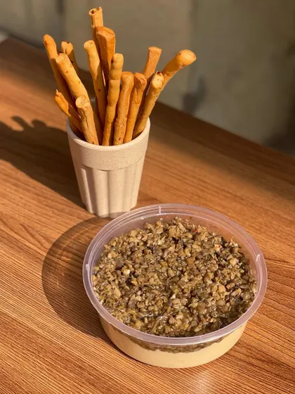 A delicious truffle-infused hummus, topped with a mix of mushrooms and seeds.