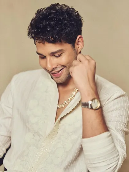 A close-up on the details. The modern gold necklace and luxury watch are the perfect accessories to elevate this classic kurta look.