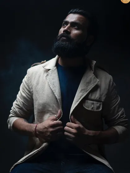 An upward-looking portrait that conveys a sense of aspiration and confidence. The lighting creates a subtle smokey effect, adding to the mood of the image.