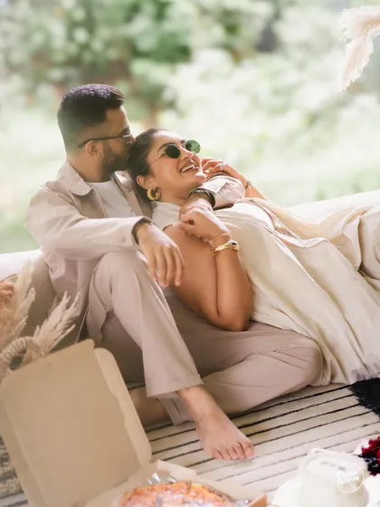 A relaxed and happy moment during an indoor picnic. The natural light and comfortable setting allow for genuine smiles and affectionate interactions, which are the heart of our candid photography style.