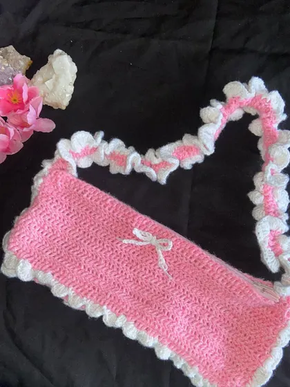My pink and white ruffle bag! This is the ultimate coquette accessory. It has a ruffled strap, a ruffled edge, and a tiny bow. It also comes with a zipper to keep your things secure.