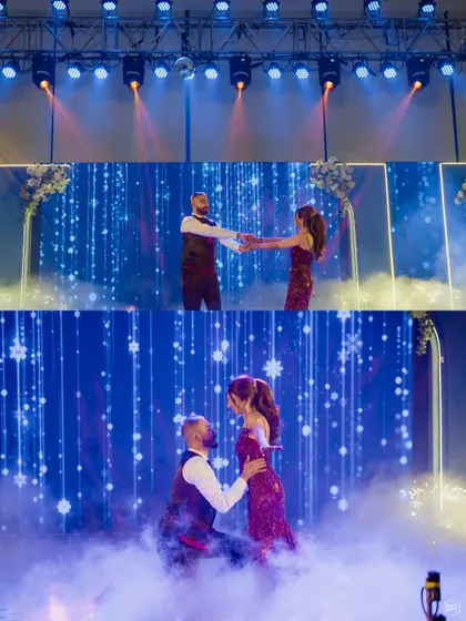The couple's romantic dance performance on a stage filled with smoke and dramatic lighting. A true fairytale moment.